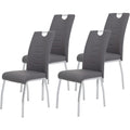 Ensemble de quatre chaises grises en similicuir avec cadre tubulaire chrome, design actuel pour espace repas